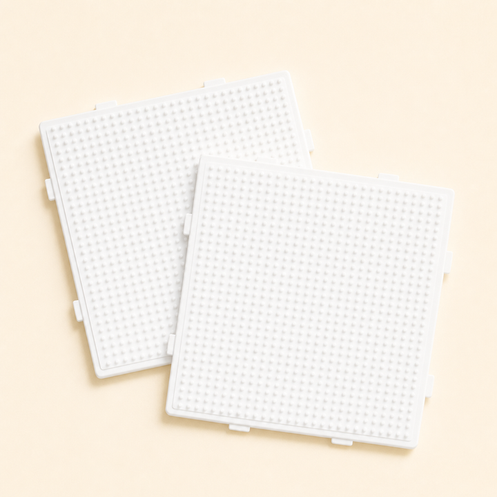 Two white fuse bead pegboards
